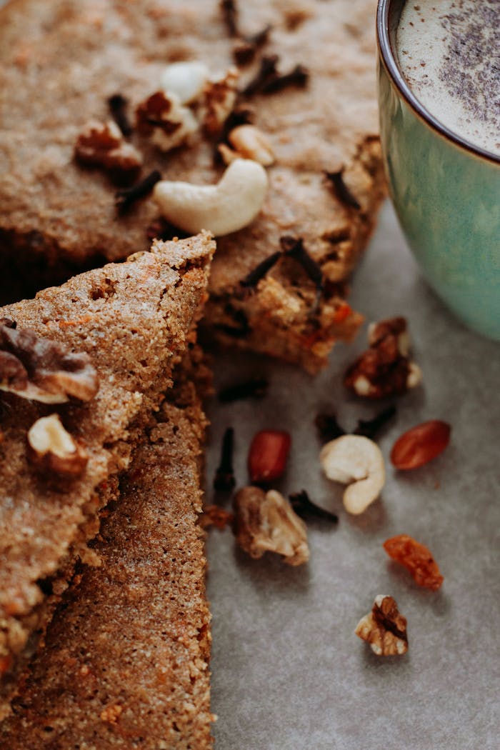 our-story-02 Close-up of nutty baked treats paired with a creamy coffee, perfect for indulgence.